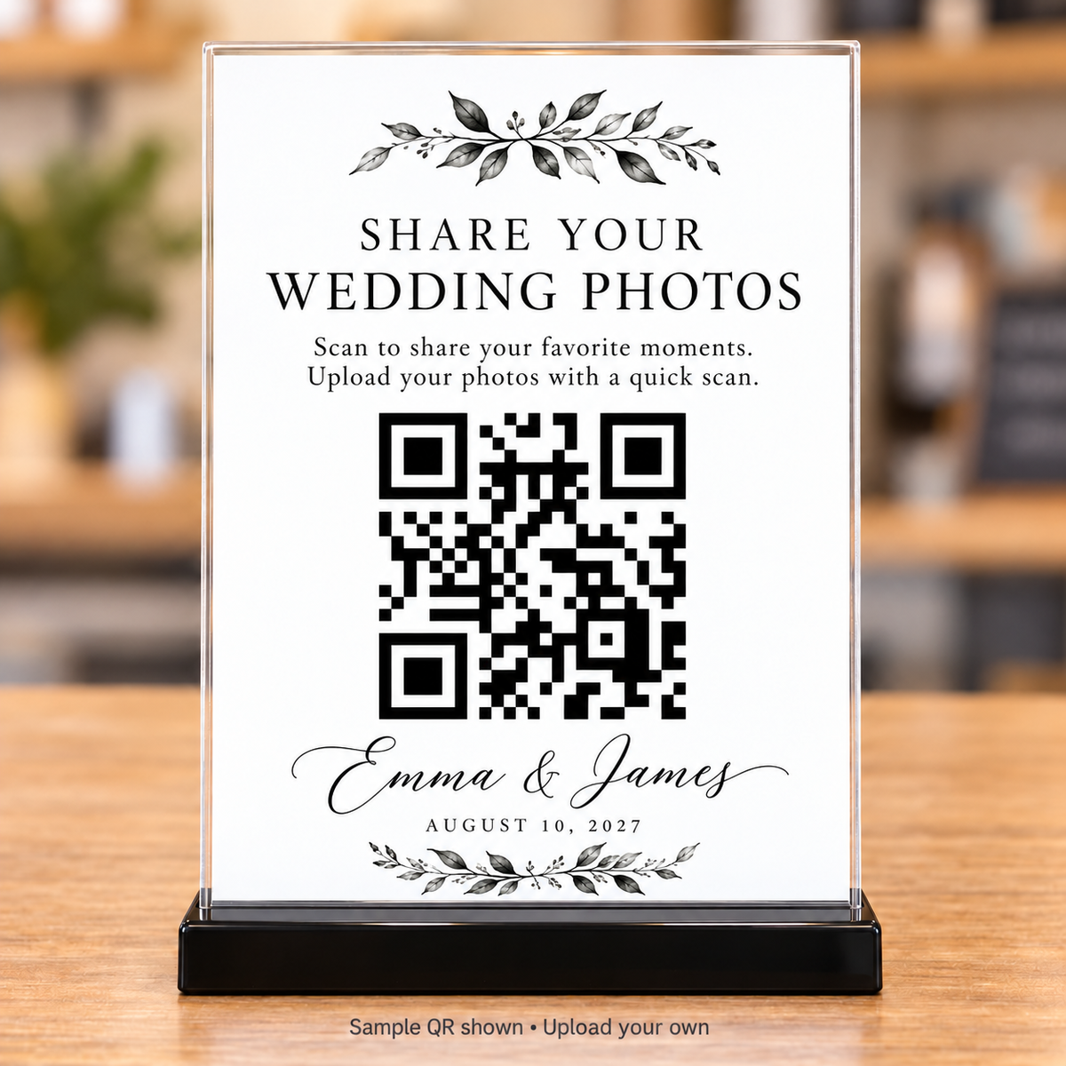 Black botanical wedding photo-sharing QR sign with leafy accents in a clear 5x7 holder and black base