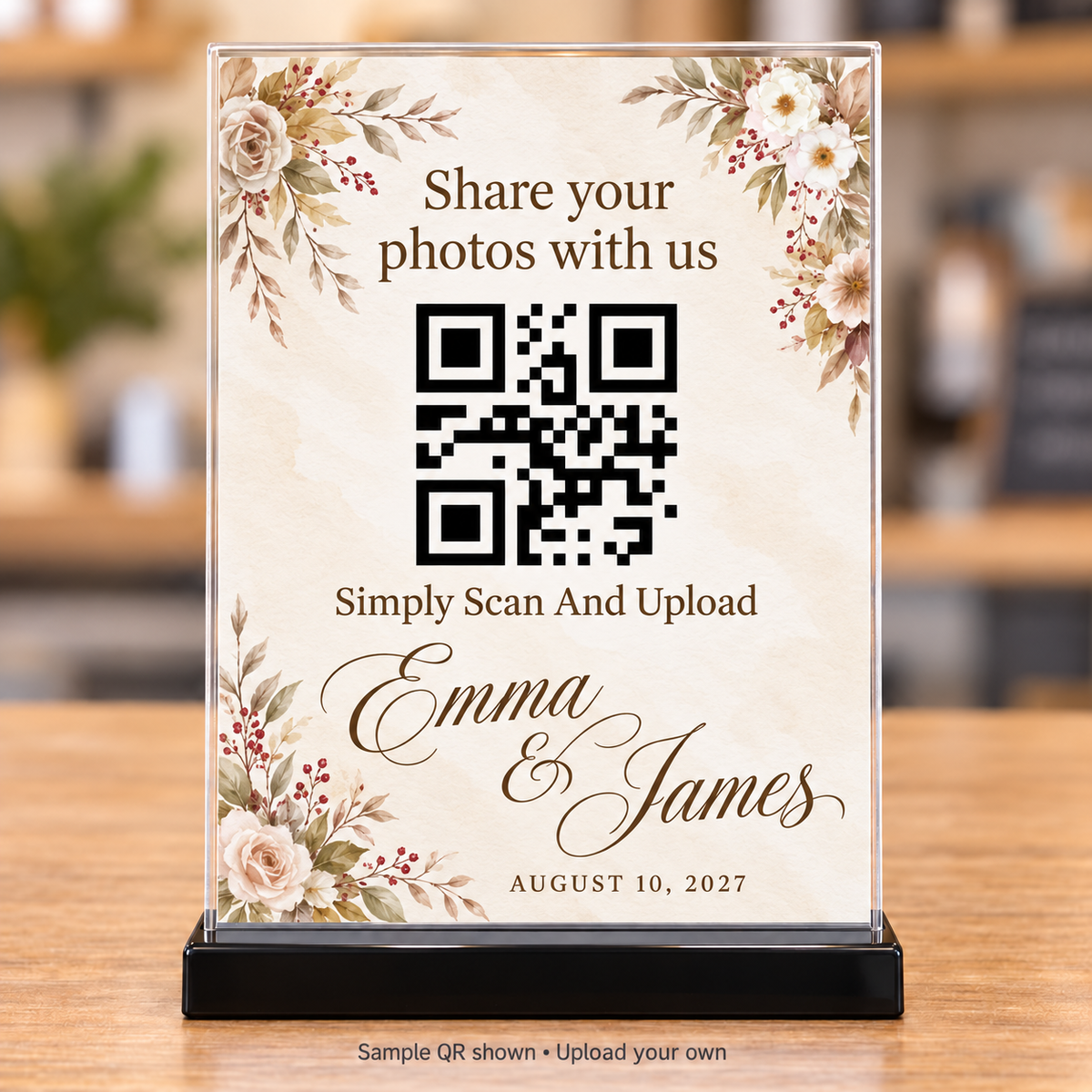 Ivory floral wedding photo-sharing QR sign with brown lettering in a clear 5x7 holder with black base