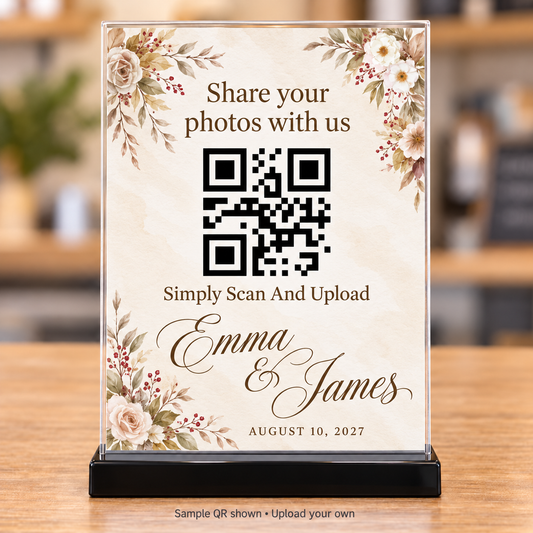 Ivory floral wedding photo-sharing QR sign with brown lettering in a clear 5x7 holder with black base