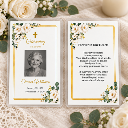 White rose and gold laminated memorial prayer cards, front and back, displayed on ivory linen with roses