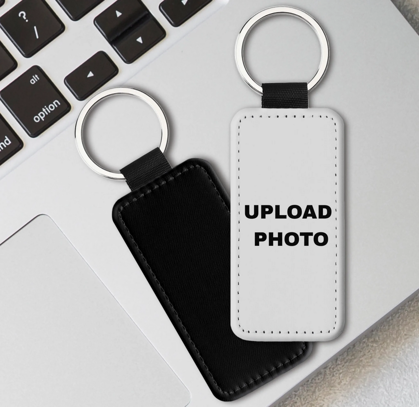 Solid black PU leather rectangle keychain personalized with photos, logos, names, and custom artwork.
